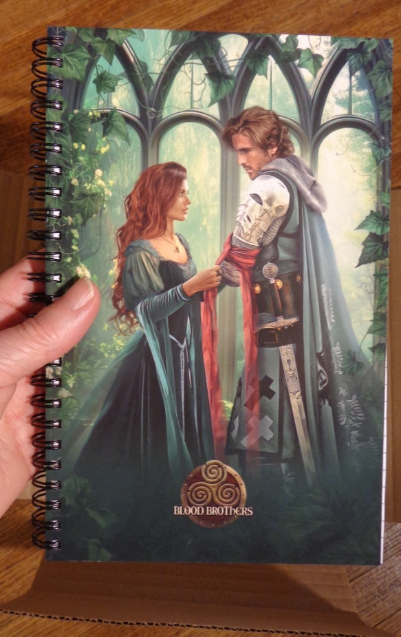 Spiral bound notebook with the cover illustration for The Hunter & the Heiress